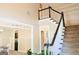 Well lit foyer with staircase and dark trim at 330 Bay Grove Rd, Loganville, GA 30052