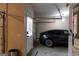 A car is parked in a clean two car garage with a white door and a water heater in the corner at 330 Bay Grove Rd, Loganville, GA 30052
