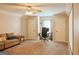 Spacious living room with plush carpeting, a ceiling fan, and a comfortable sofa at 330 Bay Grove Rd, Loganville, GA 30052