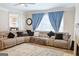 Bright living room with large sectional couch, window, and a view to the dining room at 330 Bay Grove Rd, Loganville, GA 30052