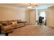 Spacious living room with plush carpeting, a ceiling fan, and a comfortable sofa at 330 Bay Grove Rd, Loganville, GA 30052