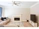 Spacious living room with cozy fireplace and ceiling fan for year-round comfort at 330 Bay Grove Rd, Loganville, GA 30052