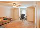 Spacious living room with plush carpeting, a ceiling fan, and a comfortable sofa at 330 Bay Grove Rd, Loganville, GA 30052