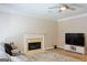 Living room with a fireplace and a ceiling fan, great for gatherings at 330 Bay Grove Rd, Loganville, GA 30052