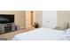 Spacious main bedroom with a television, ceiling trim, and an attached bath at 330 Bay Grove Rd, Loganville, GA 30052