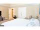 Spacious main bedroom with a television, ceiling trim, and an attached bath at 330 Bay Grove Rd, Loganville, GA 30052