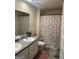 Bathroom featuring a double sink vanity with a decorative shower curtain and a soft, neutral color palette at 2276 Waycross Ln # 21, Dacula, GA 30019