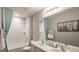 Bright bathroom with a large mirror, double sinks, shower/tub, and a turquoise shower curtain at 2276 Waycross Ln # 21, Dacula, GA 30019