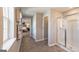 Bathroom featuring a large window, a shower, and entrances to a bedroom and hallway at 2276 Waycross Ln # 21, Dacula, GA 30019