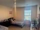 Bright bedroom featuring a window, cozy bed, and a playful touch with a cat-themed decoration on the wall at 2276 Waycross Ln # 21, Dacula, GA 30019