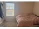 Bedroom with a comfortable bed and natural light streaming through the window, creating a serene atmosphere at 2276 Waycross Ln # 21, Dacula, GA 30019