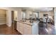 Open kitchen with stainless steel appliances, white cabinets, a center island and hardwood floors at 2276 Waycross Ln # 21, Dacula, GA 30019