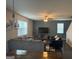 Comfortable living room featuring stylish seating, a ceiling fan, and a large television at 2276 Waycross Ln # 21, Dacula, GA 30019