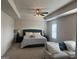 Spacious main bedroom with a tray ceiling, fan, and seating area, offering comfort and style at 2276 Waycross Ln # 21, Dacula, GA 30019