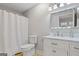 Clean bathroom with tile floors, shower, and vanity with marble countertop at 242 Adair St, Decatur, GA 30030
