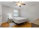 Cozy bedroom with hardwood floors, ceiling fan, window, and nightstand with lamp at 242 Adair St, Decatur, GA 30030
