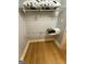 Walk-in closet features hardwood floors and metal rack shelving for storage at 242 Adair St, Decatur, GA 30030