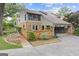 Home featuring a brick exterior, covered parking, and lush landscaping at 242 Adair St, Decatur, GA 30030