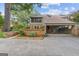Home featuring brick facade, mature trees, and covered parking area at 242 Adair St, Decatur, GA 30030