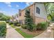 Lovely exterior view of townhome with brick facade, lush landscaping, and sidewalk at 242 Adair St, Decatur, GA 30030