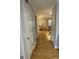 Hallway with hardwood floors leading to the staircase and front room at 242 Adair St, Decatur, GA 30030