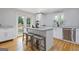 Modern kitchen features a center island with seating, stainless steel appliances, and white cabinets at 242 Adair St, Decatur, GA 30030