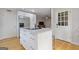 White kitchen features a marble island, stainless steel appliances, and hardwood floors at 242 Adair St, Decatur, GA 30030