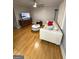 Bright living room featuring hardwood floors, a ceiling fan, and comfortable seating at 242 Adair St, Decatur, GA 30030
