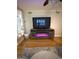 Bright living room boasts hardwood floors and a fireplace below the television at 242 Adair St, Decatur, GA 30030