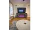 Bright living room boasts hardwood floors and a fireplace below the television at 242 Adair St, Decatur, GA 30030