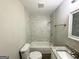 Bathroom featuring a shower over tub with marble-style tiles and granite countertops at 1991 Turner Se Rd, Atlanta, GA 30315