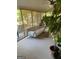 Sunroom filled with natural light, plants and a comfortable couch at 211 Groveland Dr, Peachtree City, GA 30269