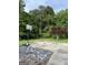View of backyard with basketball court and surrounding mature trees, great for outdoor fun at 5225 Silhouette Sw Ln, Mableton, GA 30126