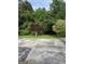 Large backyard with large trees and a concrete patio at 5225 Silhouette Sw Ln, Mableton, GA 30126