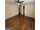 Neutral bedroom with ceiling fan, closet, and a view to another room with hardwood floors at 5225 Silhouette Sw Ln, Mableton, GA 30126