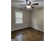 Bedroom featuring ceiling fan, window, and hardwood flooring at 5225 Silhouette Sw Ln, Mableton, GA 30126