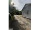 Side view of the home and long driveway with shade trees along the side and carport in back at 5225 Silhouette Sw Ln, Mableton, GA 30126