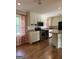 The kitchen features an island, stainless steel appliances, updated cabinets, subway tile and hardwood floors at 5225 Silhouette Sw Ln, Mableton, GA 30126