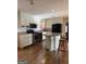 The kitchen has an island, stainless steel appliances, updated cabinets, and luxury vinyl flooring at 5225 Silhouette Sw Ln, Mableton, GA 30126