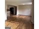 Inviting living room features hardwood floors and open access to the kitchen at 5225 Silhouette Sw Ln, Mableton, GA 30126