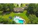Stunning aerial view of the property, showcasing the pool, backyard, and well-manicured landscaping at 125 Kayla Ct, Locust Grove, GA 30248