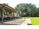 Inviting covered porch with TV, fan, and comfortable seating area, ideal for relaxation and leisure at 125 Kayla Ct, Locust Grove, GA 30248