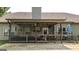 Inviting covered porch with TV, fan, and comfortable seating area, ideal for relaxation and leisure at 125 Kayla Ct, Locust Grove, GA 30248