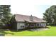 Expansive backyard with lush green grass and a covered patio, perfect for outdoor entertaining at 125 Kayla Ct, Locust Grove, GA 30248