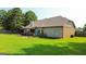 Expansive backyard features a patio, and lush lawn with potential for endless outdoor activities at 125 Kayla Ct, Locust Grove, GA 30248