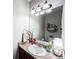 Well-lit half bathroom with a large mirror, granite countertop, and modern fixtures at 125 Kayla Ct, Locust Grove, GA 30248