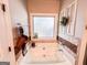 Bathroom soaking tub with a clear glass window and decorative tile surround at 125 Kayla Ct, Locust Grove, GA 30248