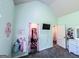 Charming bedroom with soft teal walls, closet and tv at 125 Kayla Ct, Locust Grove, GA 30248
