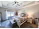 Main bedroom suite with trey ceiling, fan, and lots of natural light from windows at 125 Kayla Ct, Locust Grove, GA 30248
