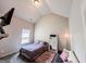 Neutral bedroom with vaulted ceilings, comfy bed, rug, and sofa at 125 Kayla Ct, Locust Grove, GA 30248